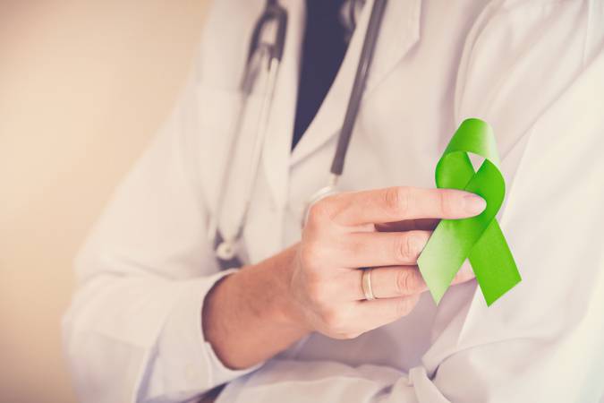 Doctor hands holding Lime Green ribbon, Mental health awareness