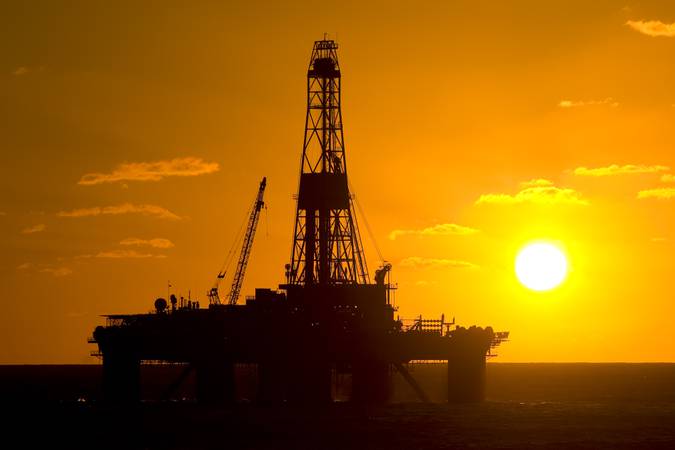 Oil drilling rig in offshore area, during sunset time.  Coast of Brazil, circa 2010.