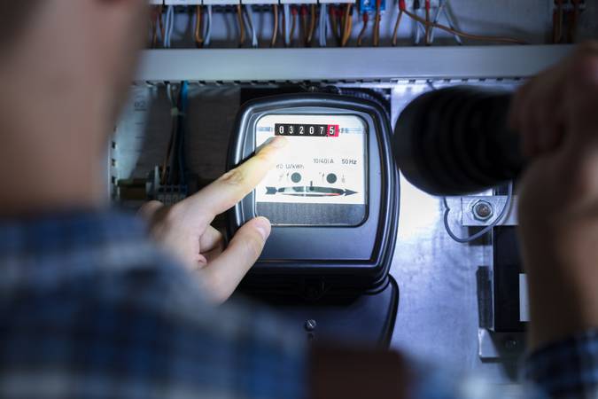 Finger Pointing To Electric Meter Reading