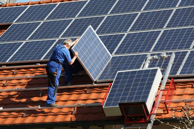 workman is mounting solar panel