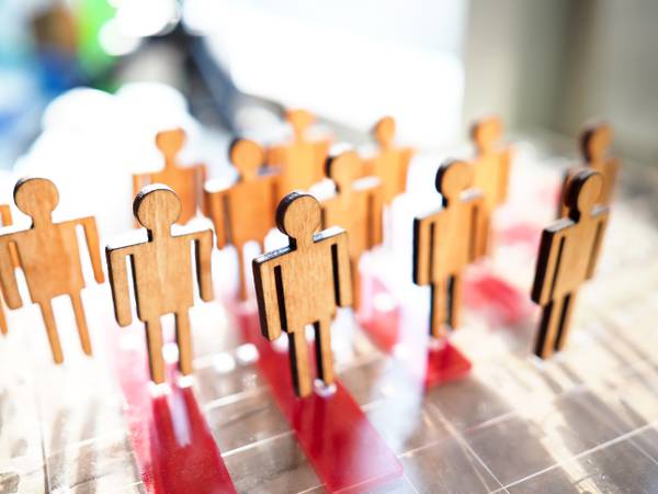 Little wooden toy people figures stand in row closeup. Teambuild hr poll net elector politics crowdfunding relationship labour talent public opinion concept
