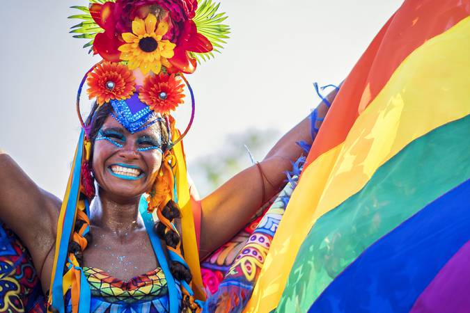 Rio de Janeiro, Brazil - February 9, 2016: Beautiful Brazilian woman of African descent wearing colourful costume and smiling at Carnaval 2016 parade in Rio de Janeiro, Brazil.